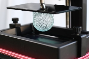 3D printer opened up to show plastic globe